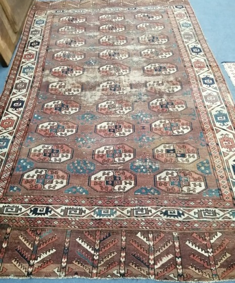 A Bokhara burgundy ground carpet 287 x 172cm